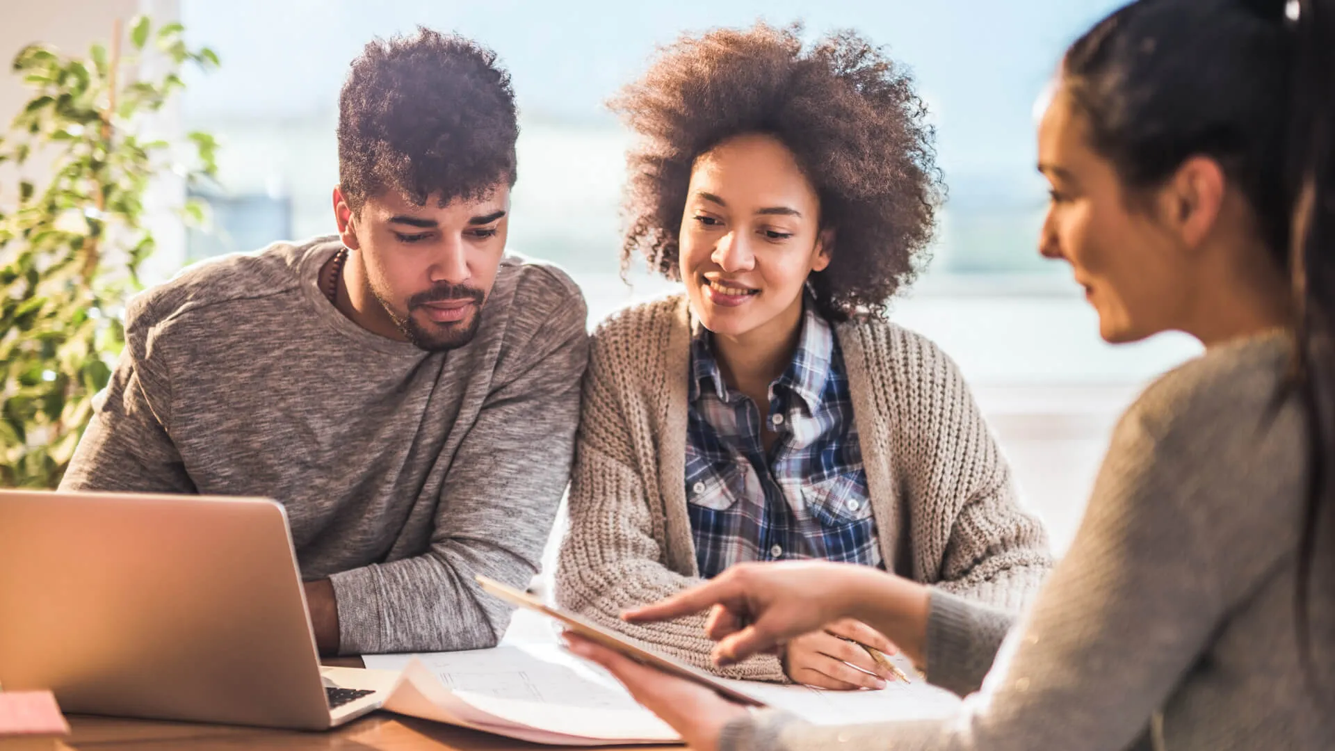 couple having a meeting with their real estate agent at home