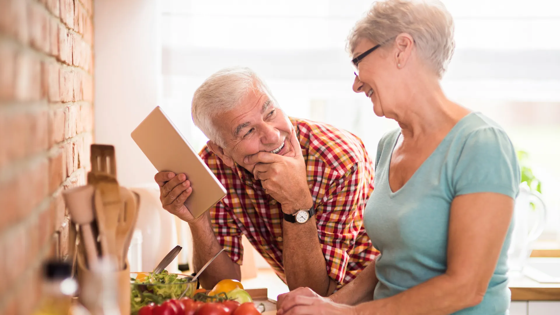 Modern senior couple spending time in the kitchen.