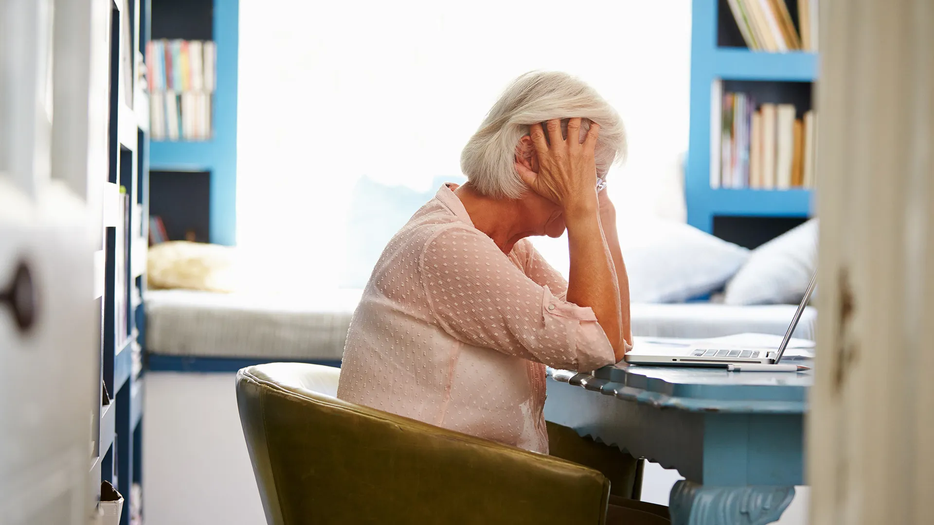 Stressed Senior Woman with laptop.