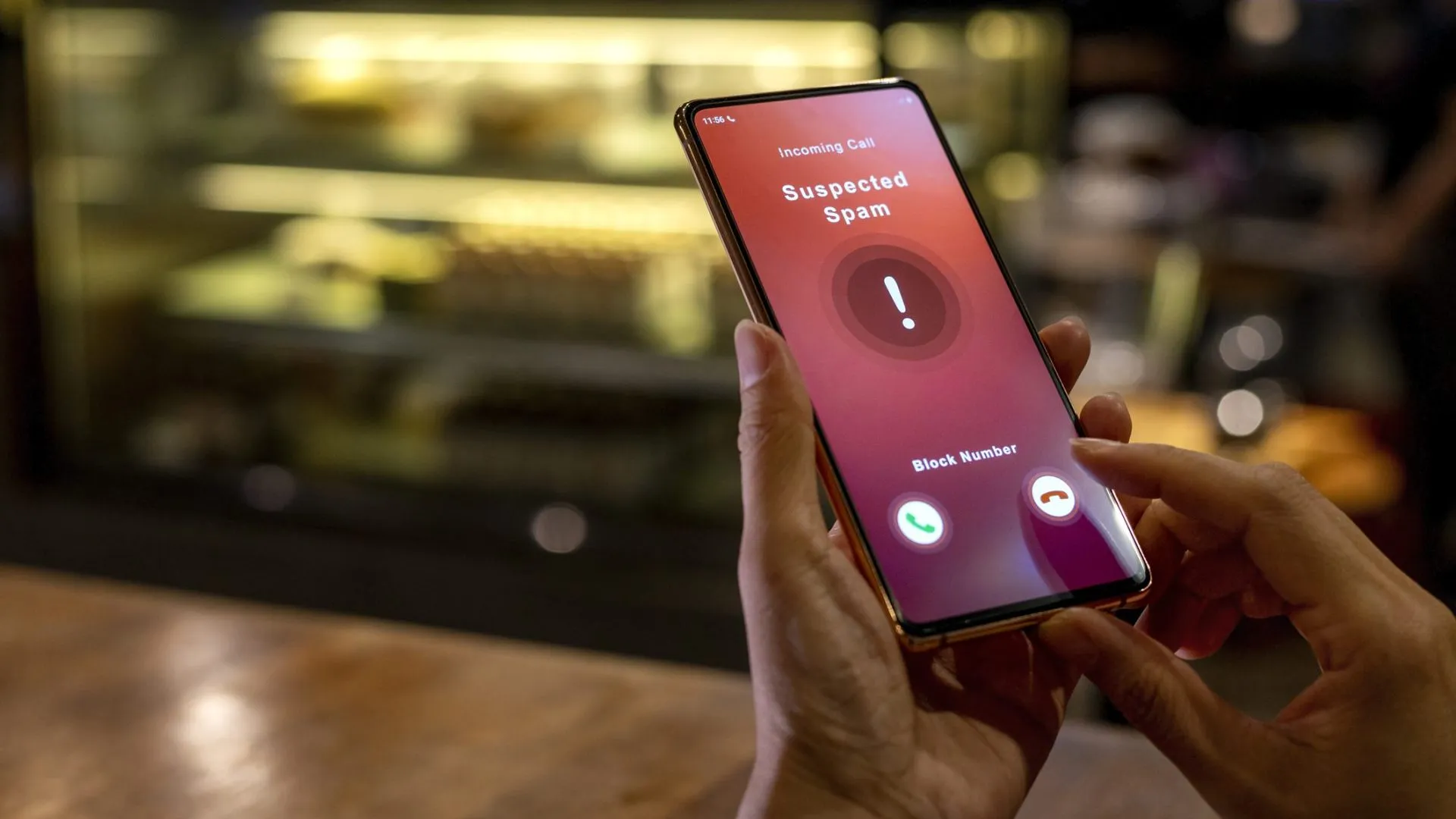 A woman receiving an incoming suspected spam call on her phone.