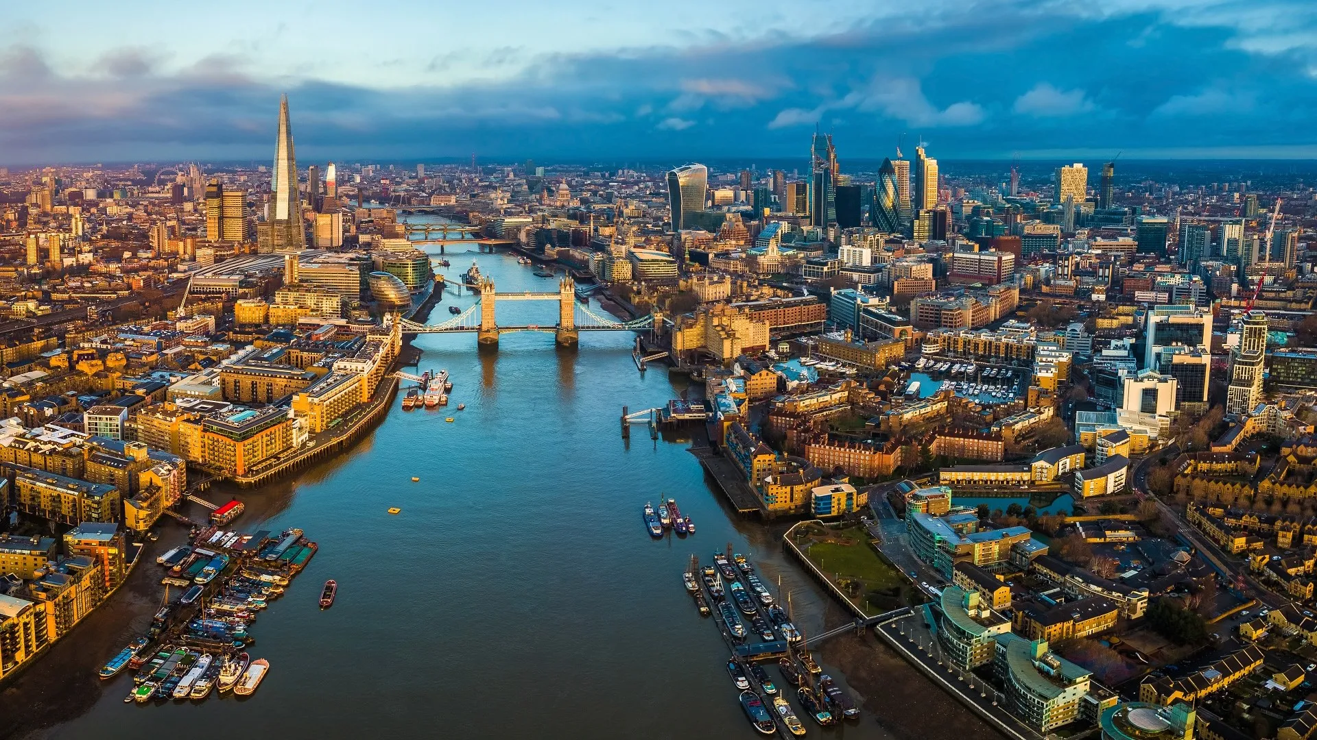 London, England - Panoramic aerial skyline view of London including Tower Bridge with red double-decker bus, Tower of London, skyscrapers of Bank District stock photo