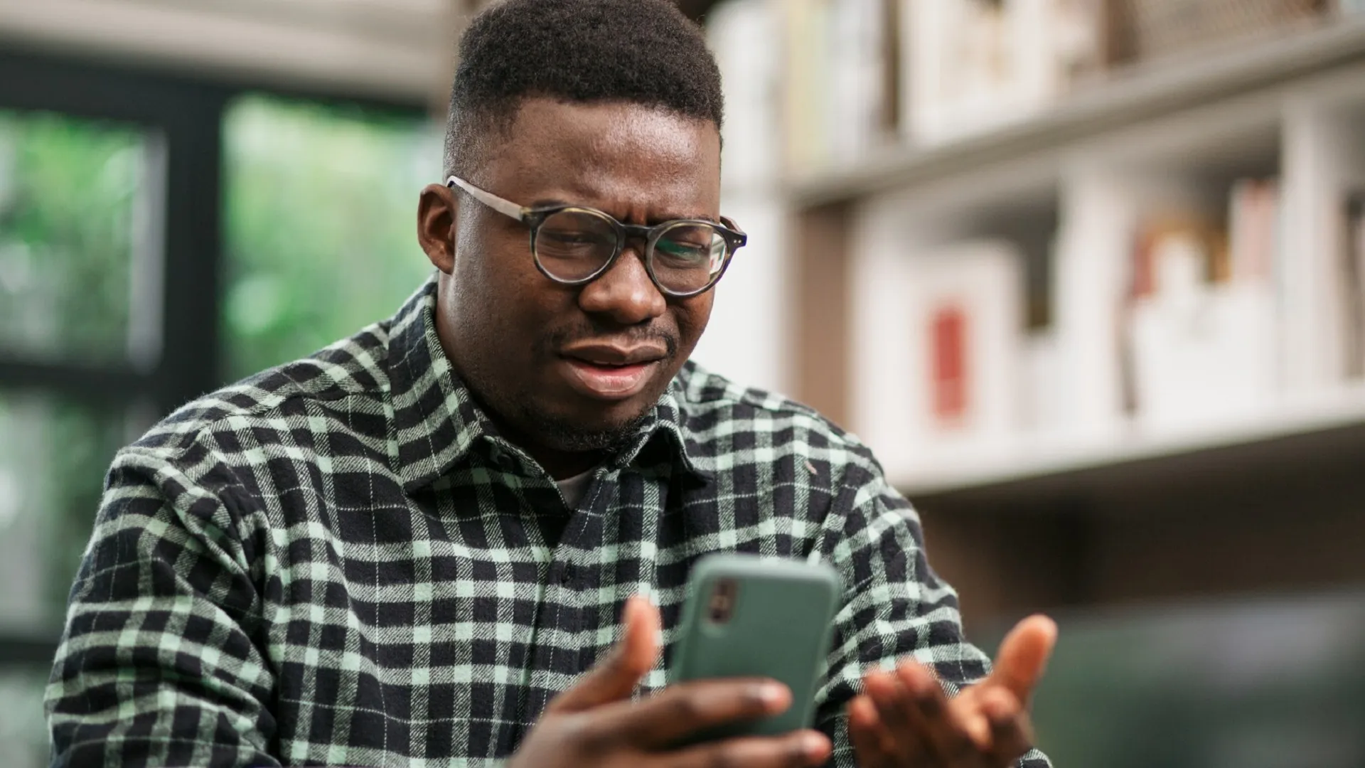 Young African American man having reading bad news on his smart phone stock photo