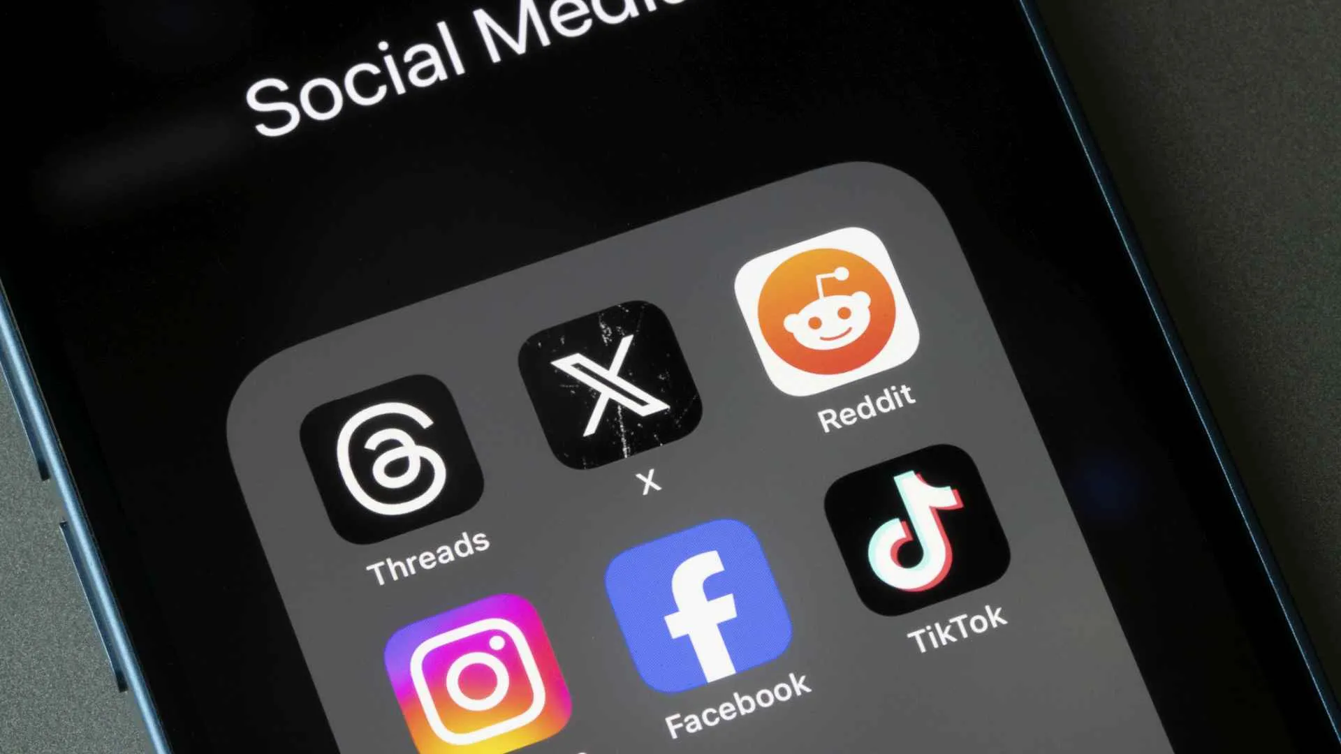 Portland, OR, USA - Oct 26, 2023: Assorted social media apps, including Threads, X, Reddit, Instagram, Facebook, and TikTok, are seen on an iPhone.