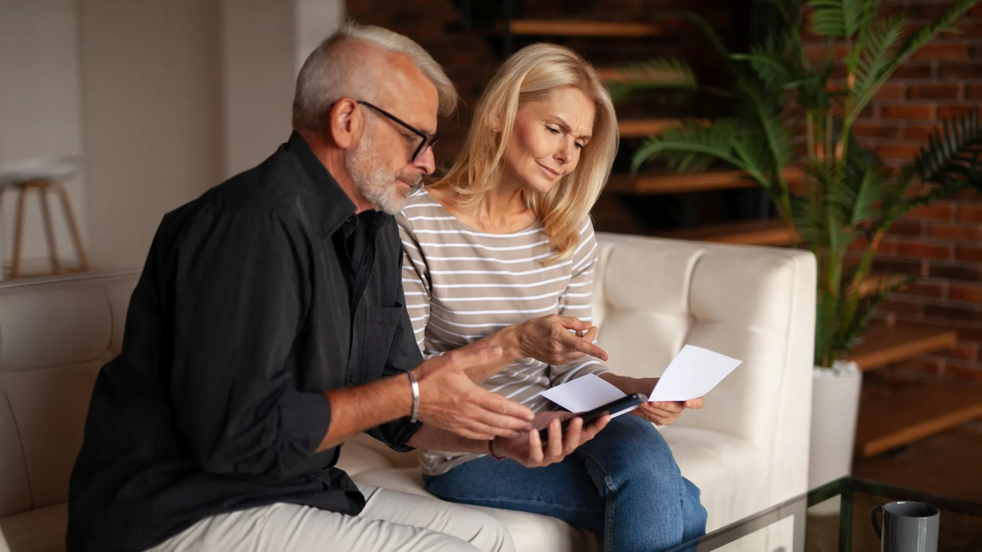 The older couple looks at the bill in confusion from an unexpected expense.