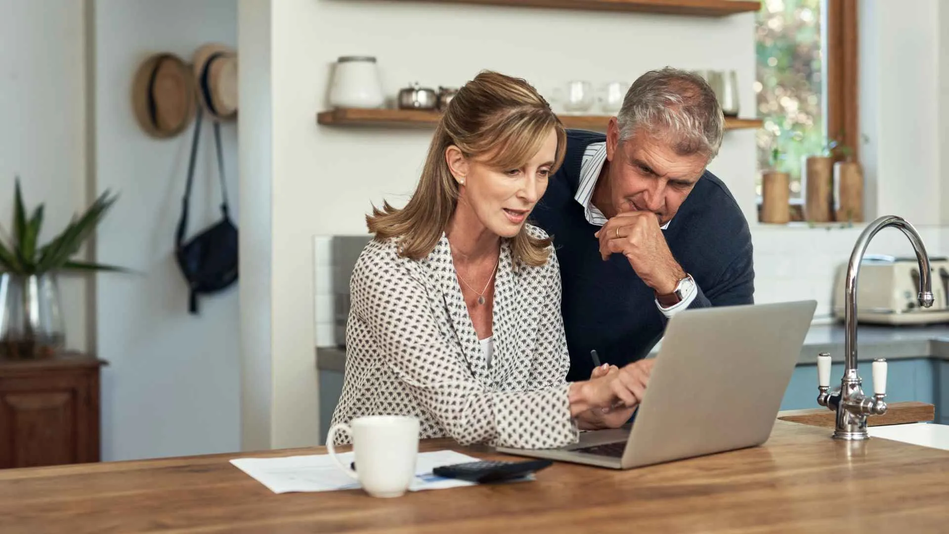 An older couple plans their finances and looks forward to retirement.